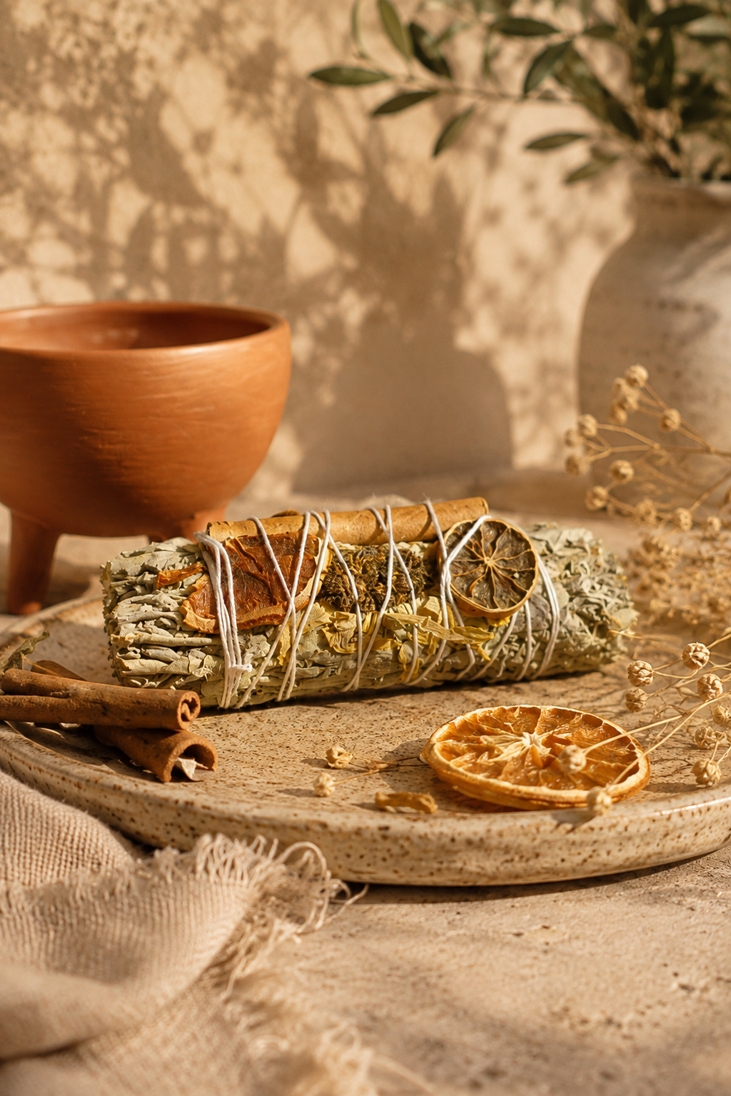 Golden Bloom Egyptian sage and sunflower smudge stick resting on a natural surface — hand harvested from the sacred mountains of Saint Catherine for positive energy rituals
