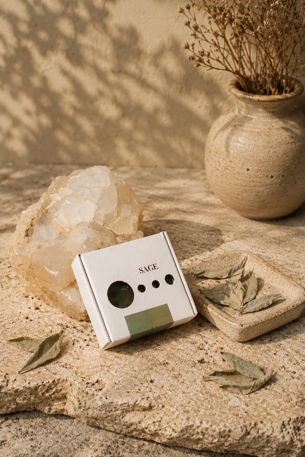 Sage soap bar in minimalist white packaging beside a raw crystal and dried Egyptian wild sage leaves — natural purifying soap handcrafted with sage from Saint Catherine, Sinai
